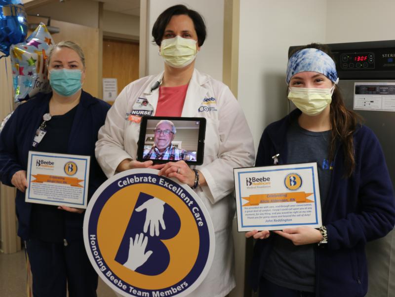 Ocean View Mayor John Reddington makes a virtual visit via iPad to thank (l-r) Ginger Farr, RN; Tara Cooper MSN, RN, Critical Care Services director; and Alicia Alderman, RN, for the excellent care they provided during his recent stay at Beebe Healthcare in Lewes. SUBMITTED PHOTO